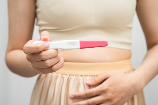 woman holding pregnancy test for female of ovulation day, fetus, maternity, birth control. photo