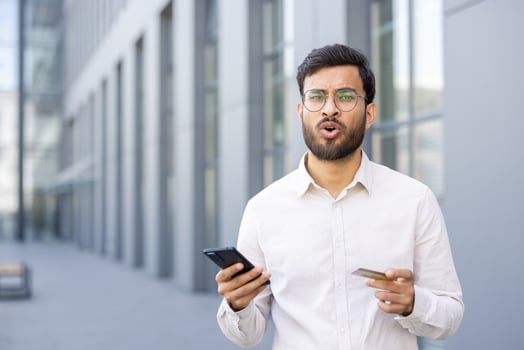 Man holding phone and credit card photo