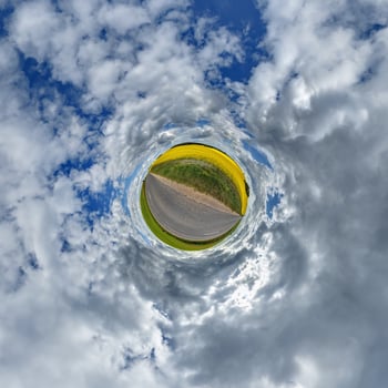 A circular view of a road and sky photo