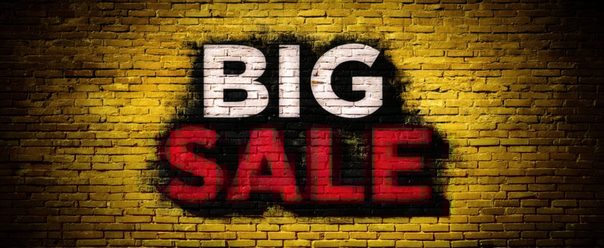The eye-catching advertisement for a big sale on a vibrant yellow wall. photo