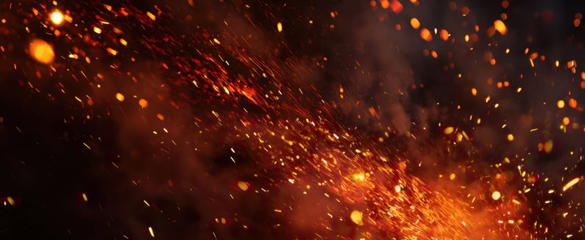 The mesmerizing dance of glowing sparks in the dark background photo