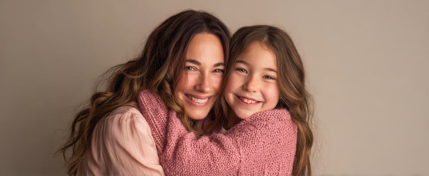 The joyful embrace of a mother and daughter sharing a happy moment. photo