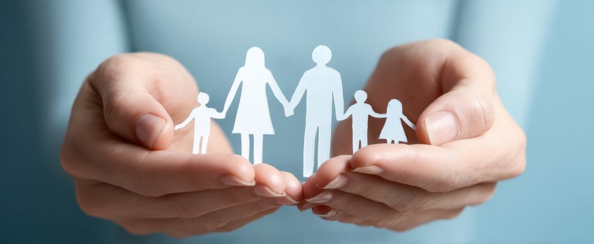 The hands supporting a paper cutout family symbolizing unity and love photo