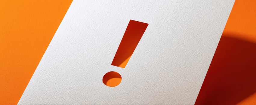 The Creative Paper Composition Featuring an Exclamation Point Cutout and Circular Hole photo