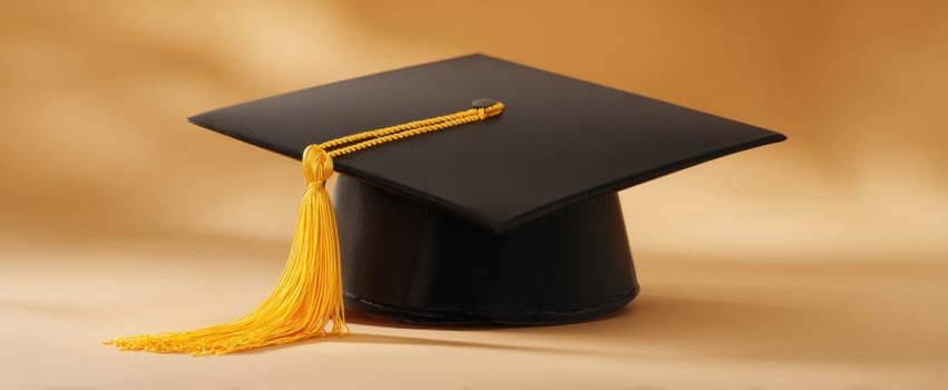 The graduation cap with yellow tassel on a soft background. photo