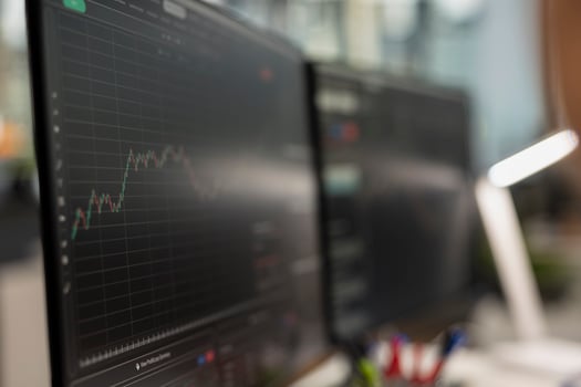 Close up of computer monitor displaying candlestick chart with stock market trends and price movements. Trading interface on PC screen showing financial data analysis of stock exchange performance photo