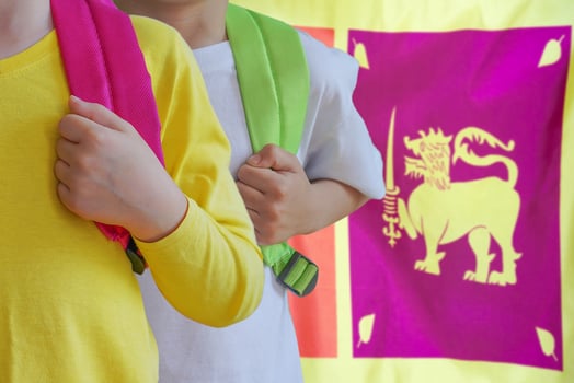 Two kids with satchels background of Sri Lanka flag photo
