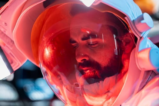 Astronaut sits alone in dim space station corner, showing signs of emotional exhaustion after long isolation. Cosmonaut having psychological crisis in starship cabin, feeling lonely, close up photo