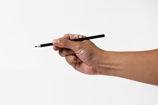 Hand of Asian man holding black pencil on white background photo
