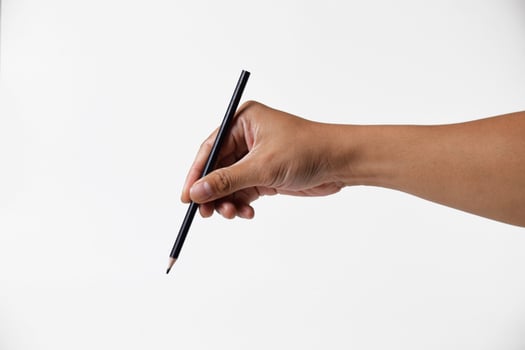 Closeup of Asian man hand holding black pencil on white background photo