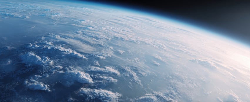 The Earth from Orbit Showing Curved Horizon Oceans and Cloud Layers at Dawn photo