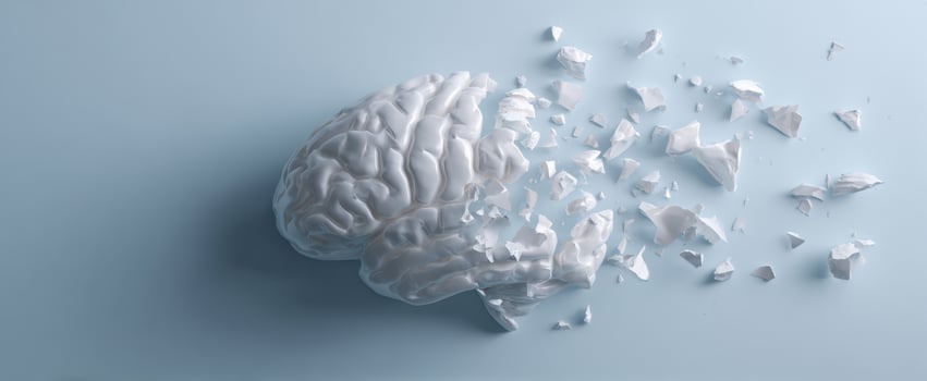 The Brain Sculpture Shattering Into Fragmented Ceramic Shards On Pale Blue Surface photo