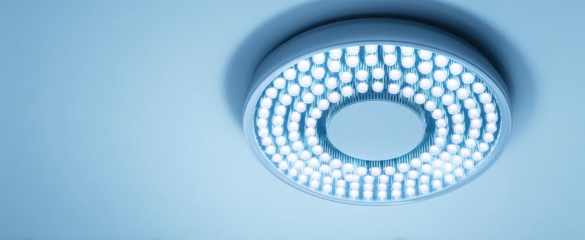 The LED ceiling light fixture casting cool blue ambient illumination in modern interior photo