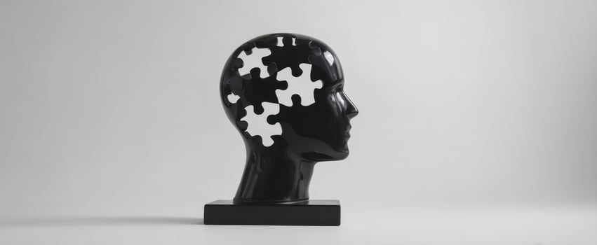 The head sculpture with puzzle-shaped missing pieces representing memory loss and mental health photo