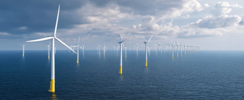The Offshore Wind Farm Stretching Across a Calm Sea under Dramatic Cloud Filled Skies photo