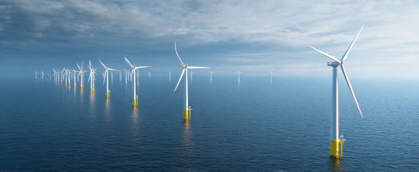 The Offshore Wind Farm Stretching Across Calm Ocean Under a Blue Sky photo