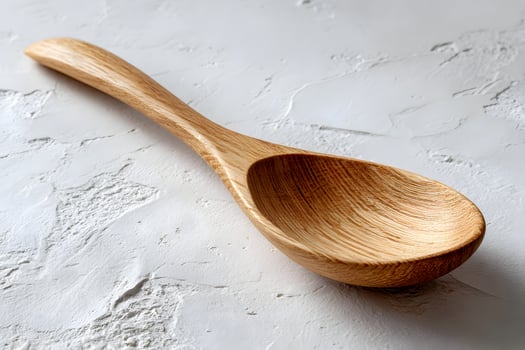 Wooden Cooking Spoon on White Textured Surface in Kitchen Style photo
