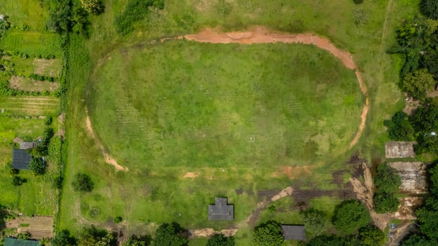 Aerial view of football field with dirt running track in the countryside area of Chiang Rai province of Thailand. The sport field in the countryside view from drone. photo