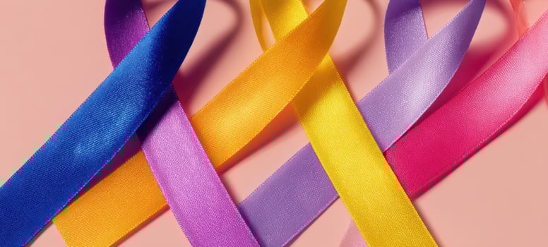 The Satin Awareness Ribbons Crossed in Colorful Pastel Loops on Pink Background photo