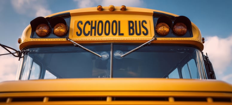The School Bus Front Close-Up Under Blue Sky With Warm Sunset Lighting photo