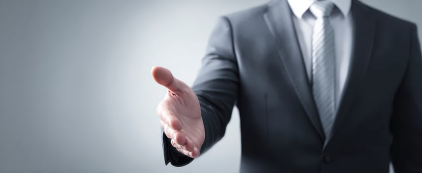 The businessman offering a handshake to seal a professional deal in a studio photo