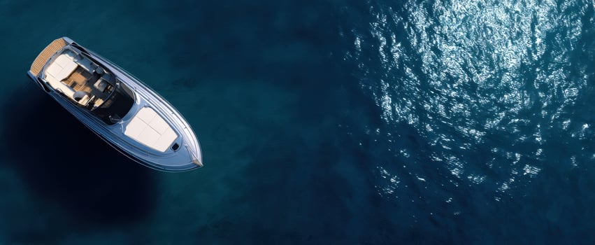 The yacht glides across deep blue ocean with sunlit reflections and open deck photo
