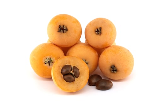 Loquat fruits and seeds showing pulp and peel isolated on white background. photo