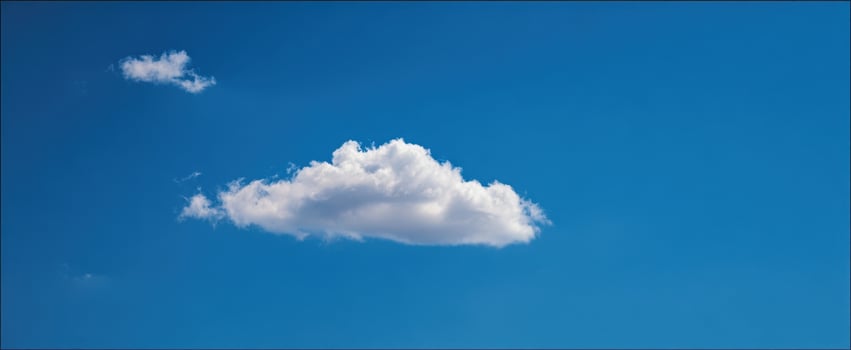 The Cloud Floating Alone Against a Vast Clear Blue Sky on a Sunny Day photo