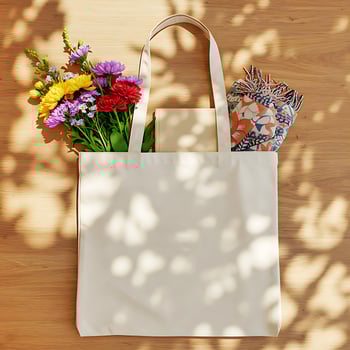 Canvas Tote Bag Mockup with Colorful Flowers and Patterned Fabric on Wooden Background photo