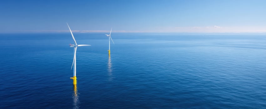 The Offshore Wind Turbines Standing Over Calm Blue Ocean Under Clear Sky at Daylight photo
