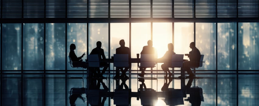 The Business Meeting Around a Glass Conference Table with City Skyline Backdrop photo