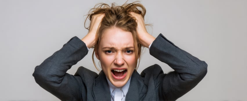 The woman clutching her hair in a dramatic business stress and frustration moment photo