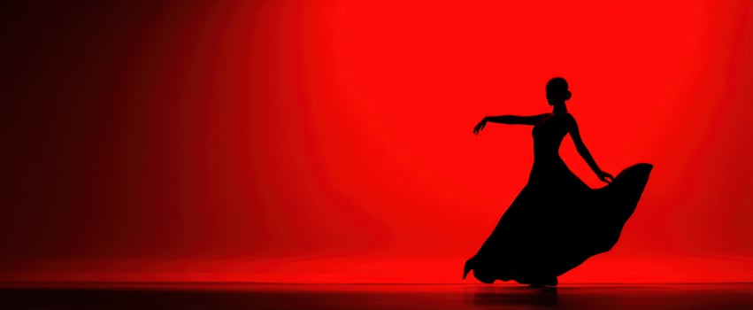 The Dancer in Flowing Gown Silhouetted on a Dramatic Red Stage Backdrop photo