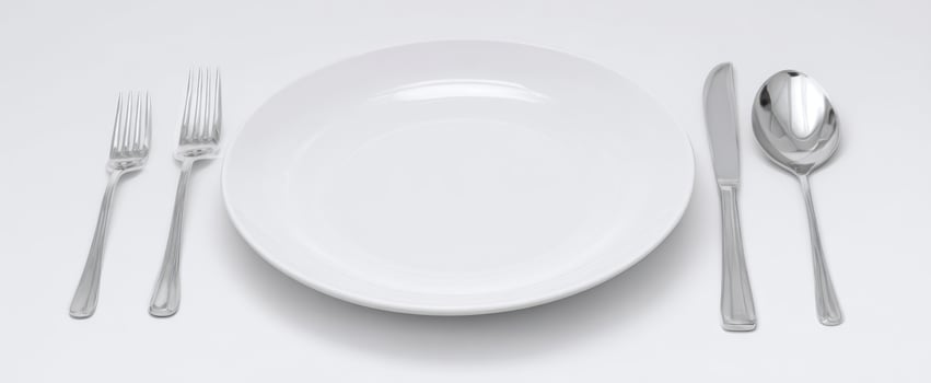 The White Ceramic Plate and Silver Cutlery Minimalist Dining Table Setting on White photo