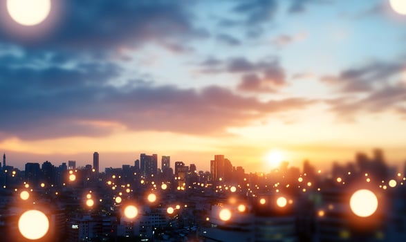 City sunset skyline, urban lights bokeh, evening glow, cityscape background, website header photo