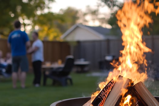 Backyard bonfire, friends chatting, summer evening gathering photo
