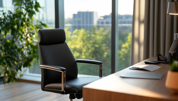 Modern office chair near desk, city view photo