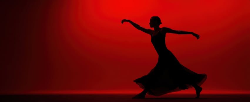 The Ballerina Silhouette Dancing Gracefully Across a Minimal Red Stage in Motion photo