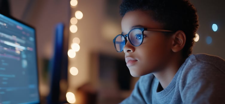 Boy coding at night, home, lights. Education photo