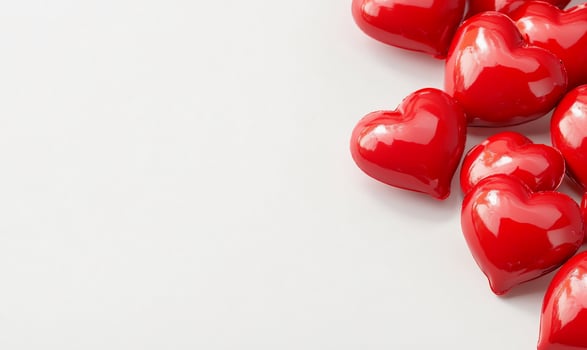 A collection of glossy red hearts on a clean white background, symbolizing love and affection, perfect for romantic themes photo