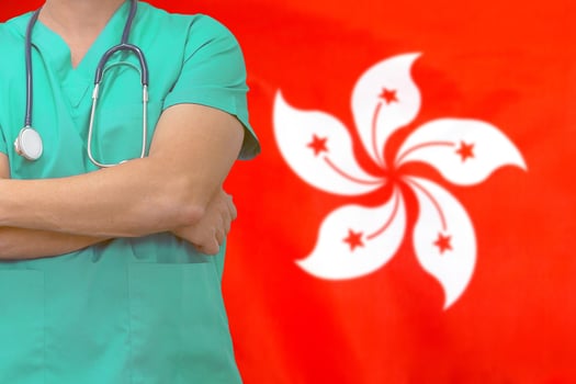 Man surgeon or doctor with stethoscope on the background of the Hong Kong flag. Health care, surgery and medical concept in Hong Kong. photo