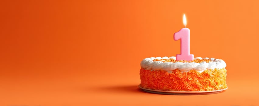 The Cake with a Pink Number One Candle on Bright Orange Background photo