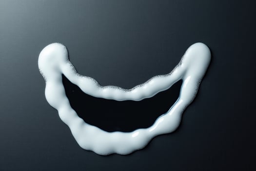 Minimalist milk foam smile on black background closeup shot photo