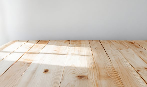 Sunlight on wooden table, white wall background, product display photo