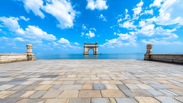 Coastal archway under blue sky, calm sea photo