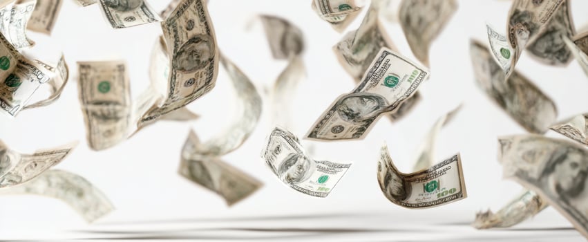 The Dollar Bills Falling Through the Air Over a Clean White Studio Background photo