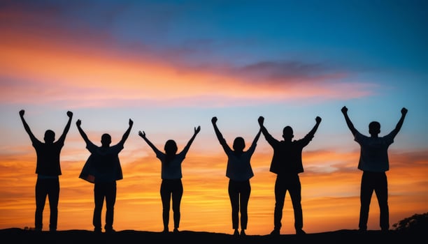 Silhouettes of Triumphant People at Sunset Horizon. photo