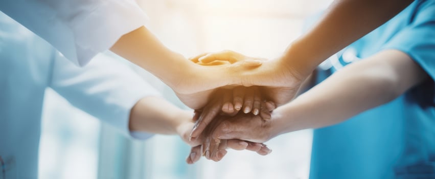 The Hands of a Medical Team Joining Together to Show Unity and Support photo