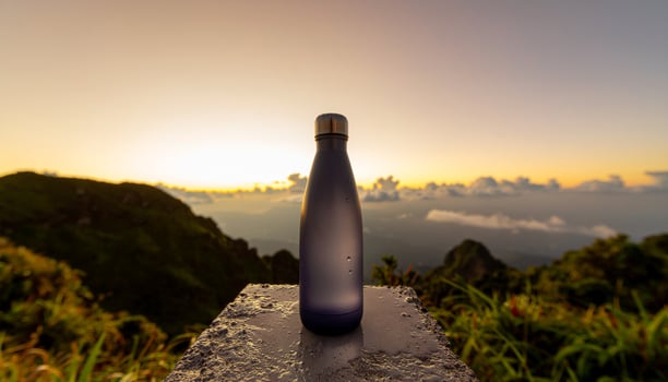 Violet Cylinder Bottle on Marble Rock photo