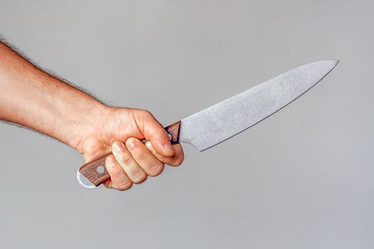 Big kitchen knife in caucasian man hand photo